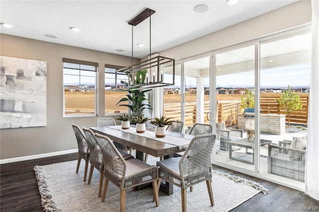 dining space with a healthy amount of sunlight and dark hardwood / wood-style flooring