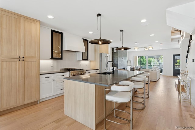 1647 N Osceola St, Denver, CO 80204 - kitchen with premium range hood, dark countertops, range, a sink, and open floor plan