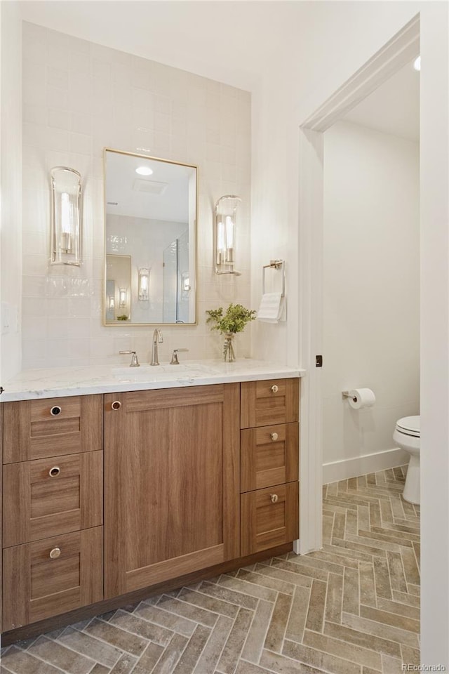 1647 N Osceola St, Denver, CO 80204 - bathroom with vanity, toilet, and baseboards