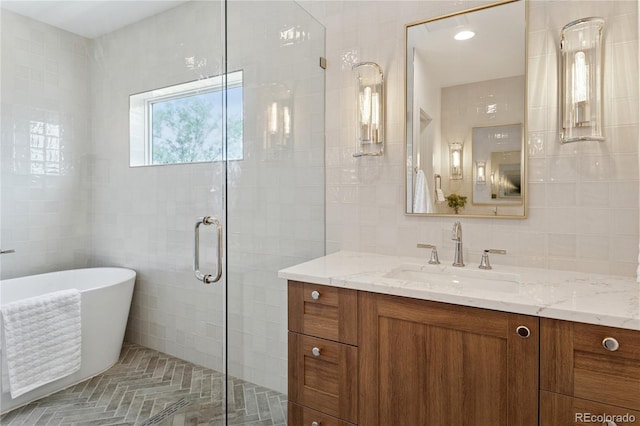 1647 N Osceola St, Denver, CO 80204 - bathroom featuring tile walls, vanity, a soaking tub, and a stall shower