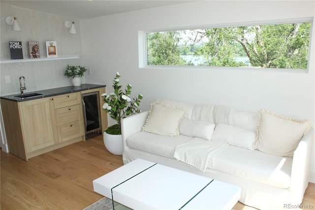 1647 N Osceola St, Denver, CO 80204 - living area with wine cooler, light wood finished floors, and wet bar