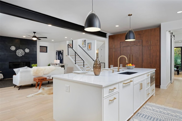 kitchen featuring decorative light fixtures, recessed lighting, light wood-type flooring, and paneled refrigerator