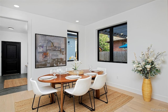 dining space featuring recessed lighting, baseboards, and wood finished floors