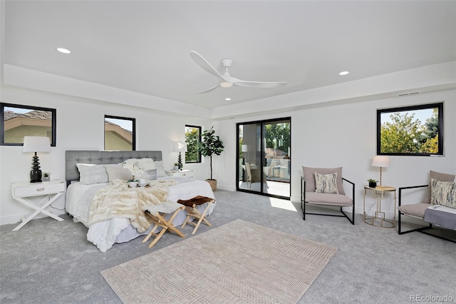 bedroom with recessed lighting, light carpet, and access to exterior