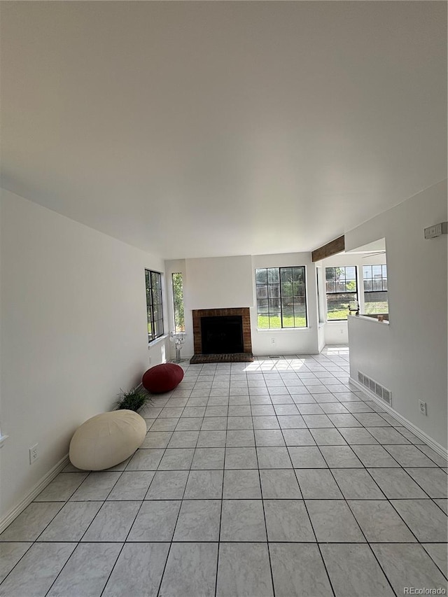 4362 Denmark Ct, Denver, CO 80239 - unfurnished living room featuring a fireplace and light tile patterned floors