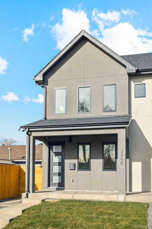 rear view of house with a yard