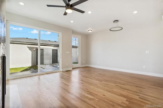 unfurnished living room with light hardwood / wood-style flooring and ceiling fan