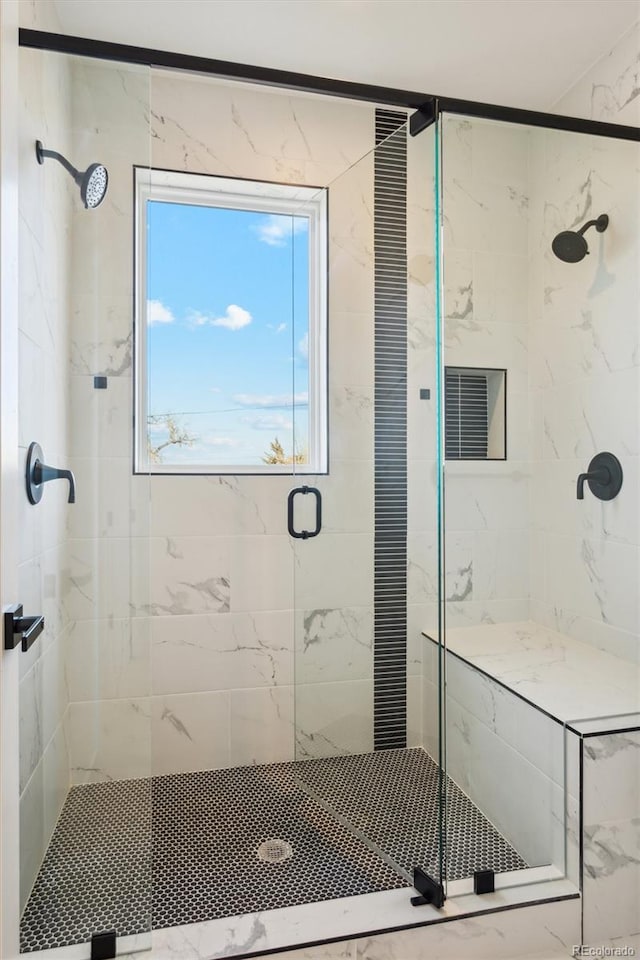 bathroom with a shower with door