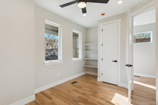 unfurnished bedroom with ceiling fan and light hardwood / wood-style flooring