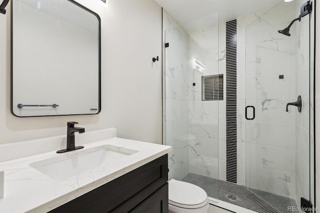 bathroom with walk in shower, vanity, and toilet