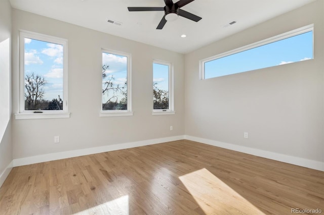 empty room featuring ceiling fan and light hardwood / wood-style flooring