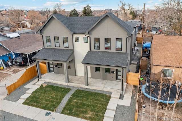 view of front of property with a patio and a trampoline