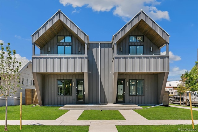 2403 S Cherokee St, Denver, CO 80223 - contemporary house featuring a balcony, board and batten siding, and covered porch