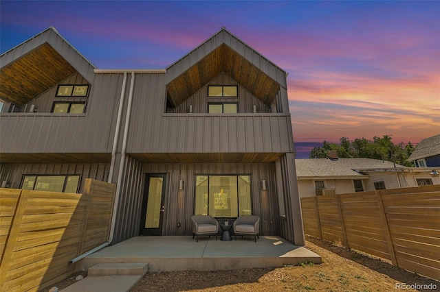 2403 S Cherokee St, Denver, CO 80223 - back of property featuring a balcony, board and batten siding, and a patio