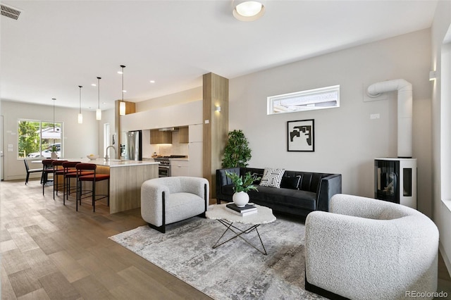 2403 S Cherokee St, Denver, CO 80223 - living area featuring light wood-style flooring and recessed lighting