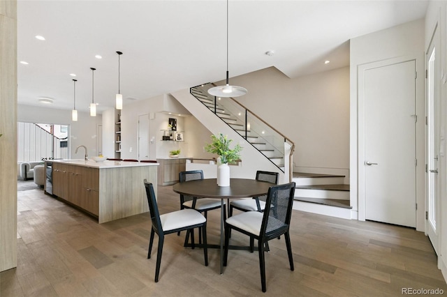 2403 S Cherokee St, Denver, CO 80223 - dining space with light wood-style flooring, stairway, and recessed lighting