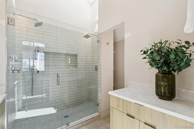 2403 S Cherokee St, Denver, CO 80223 - full bath featuring a stall shower, vanity, and tile patterned flooring