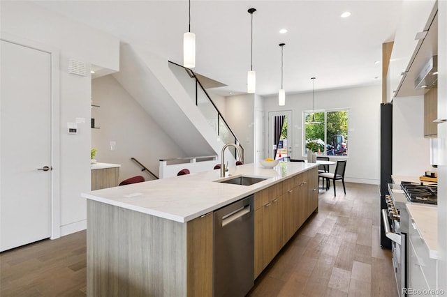 2403 S Cherokee St, Denver, CO 80223 - kitchen featuring modern cabinets, appliances with stainless steel finishes, recessed lighting, light wood-style floors, and a spacious island