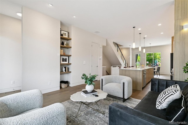 2403 S Cherokee St, Denver, CO 80223 - living room with light wood-style flooring, stairway, and recessed lighting