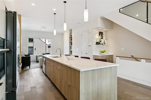 2403 S Cherokee St, Denver, CO 80223 - kitchen featuring modern cabinets, wood finished floors, a spacious island, pendant lighting, and recessed lighting