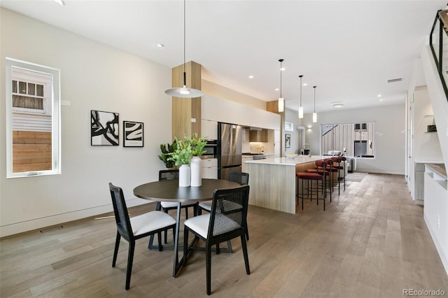 2403 S Cherokee St, Denver, CO 80223 - dining space with light wood-style flooring and recessed lighting