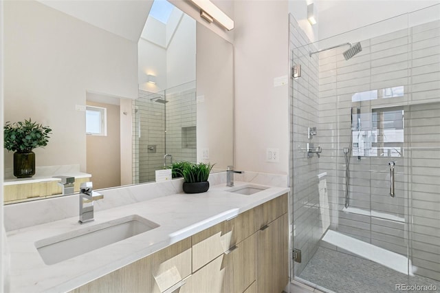 2403 S Cherokee St, Denver, CO 80223 - full bath featuring a stall shower, double vanity, and a skylight