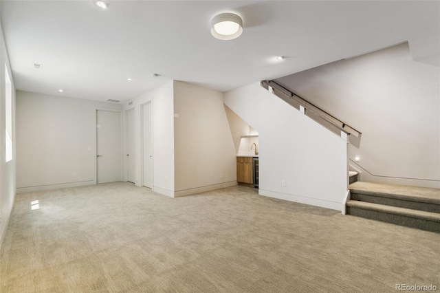2403 S Cherokee St, Denver, CO 80223 - unfurnished living room featuring stairway, recessed lighting, light carpet, and bar area