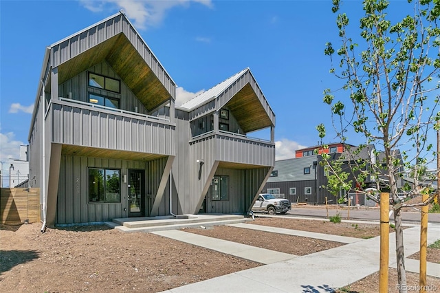 2403 S Cherokee St, Denver, CO 80223 - view of front facade featuring board and batten siding and a balcony