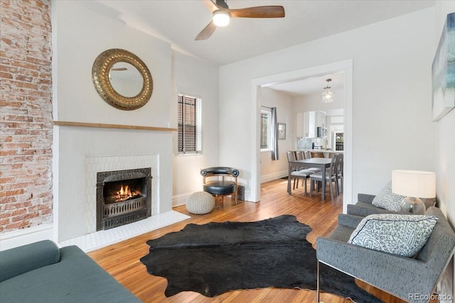 3953 Tejon St, Denver, CO 80211 - living area featuring wood finished floors, a ceiling fan, a fireplace with flush hearth, and baseboards