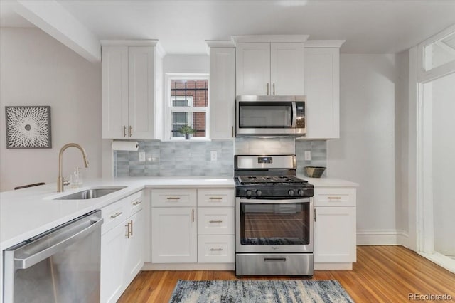 3953 Tejon St, Denver, CO 80211 - kitchen featuring appliances with stainless steel finishes, a sink, backsplash, and light countertops