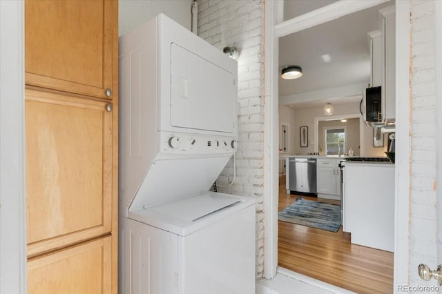 3953 Tejon St, Denver, CO 80211 - laundry room with stacked washing machine and dryer and light wood finished floors