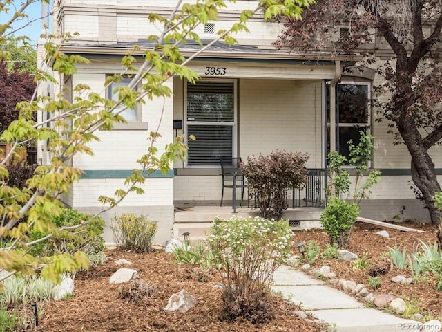 3953 Tejon St, Denver, CO 80211 - property entrance with covered porch and brick siding