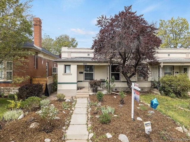 3953 Tejon St, Denver, CO 80211 - view of front of house featuring covered porch, brick siding, and a chimney