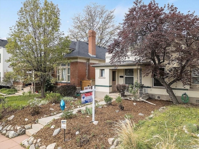 3953 Tejon St, Denver, CO 80211 - view of front of property featuring covered porch, a chimney, and brick siding
