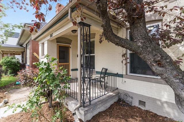 3953 Tejon St, Denver, CO 80211 - property entrance with brick siding, a porch, and a chimney