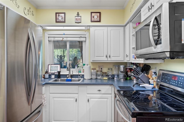 kitchen featuring white cabinets, dark countertops, appliances with stainless steel finishes, a sink, and ornamental molding