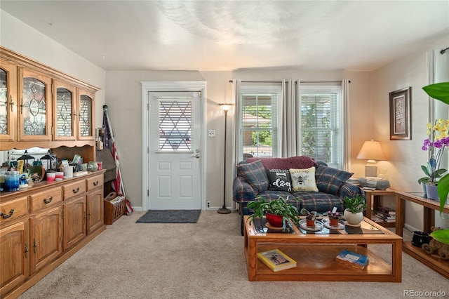 interior space with baseboards and light carpet