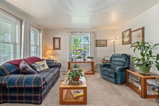 carpeted living room with baseboards