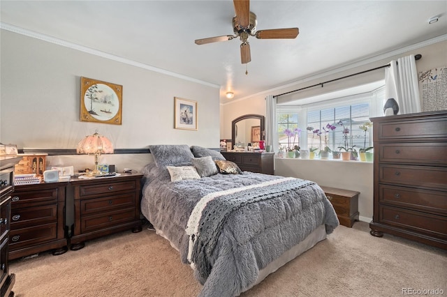 bedroom featuring baseboards, ornamental molding, ceiling fan, and light carpet