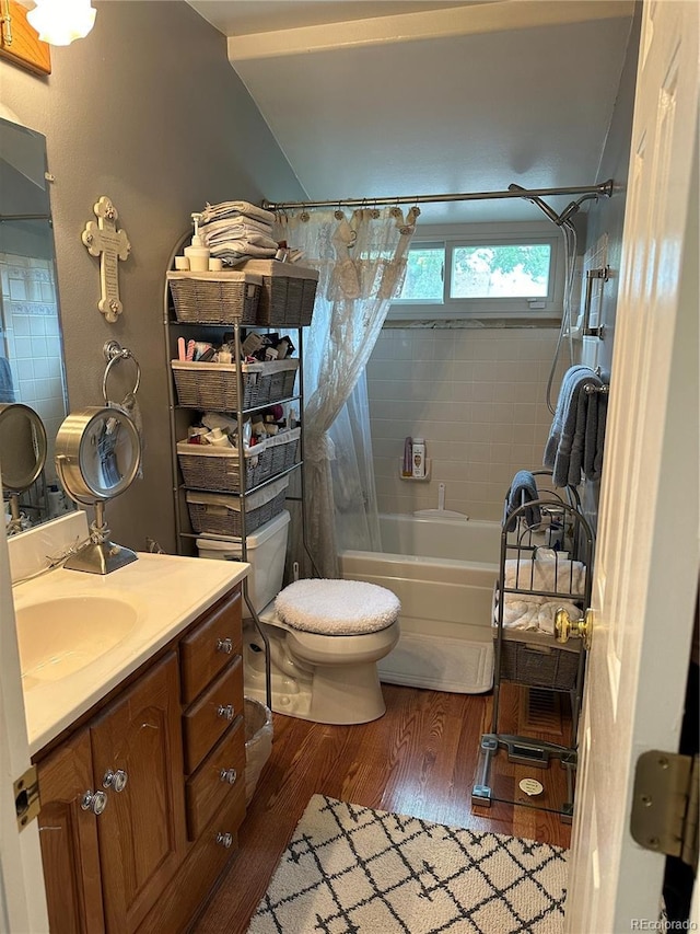 bathroom featuring vanity, shower / bathtub combination with curtain, wood finished floors, and toilet