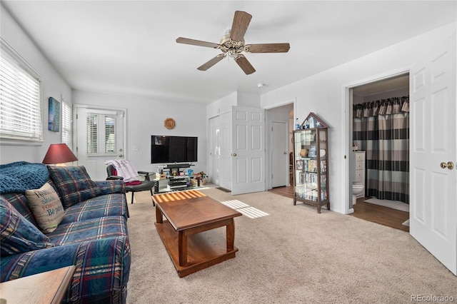 living room with carpet flooring and a ceiling fan