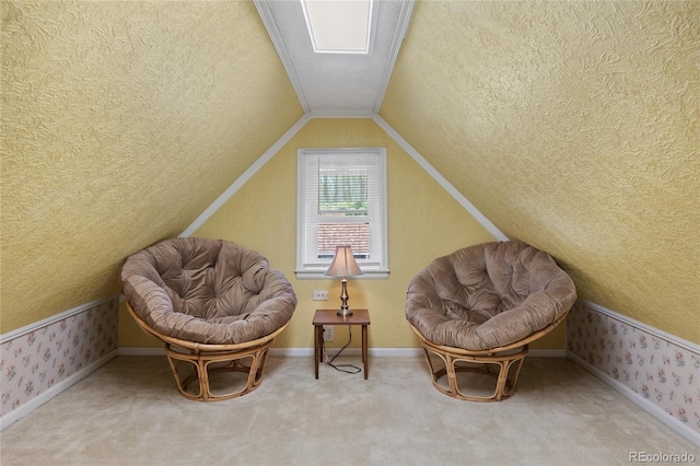sitting room featuring baseboards, carpet, and vaulted ceiling
