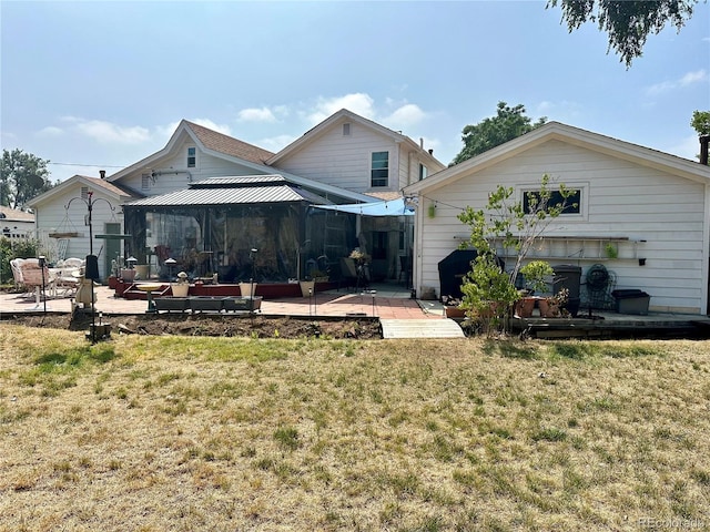 back of property with a gazebo, a yard, and a patio area