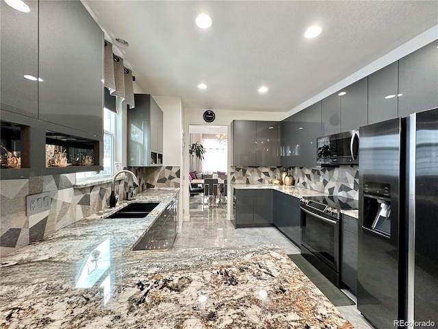 kitchen featuring a sink, appliances with stainless steel finishes, gray cabinetry, and modern cabinets