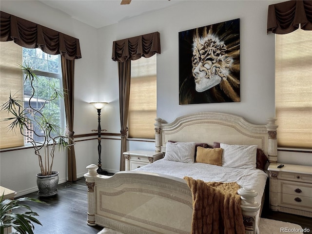 bedroom with wood finished floors and baseboards