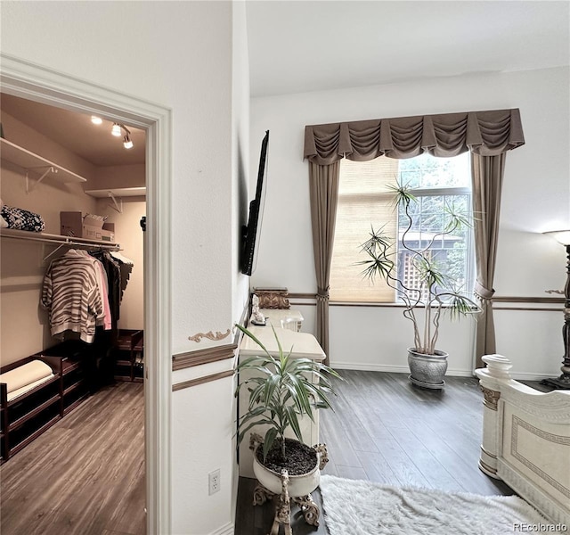 interior space featuring baseboards and wood finished floors