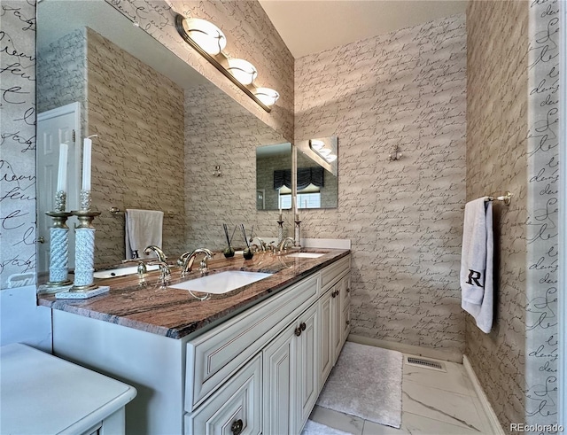 full bathroom with a sink, visible vents, double vanity, and marble finish floor