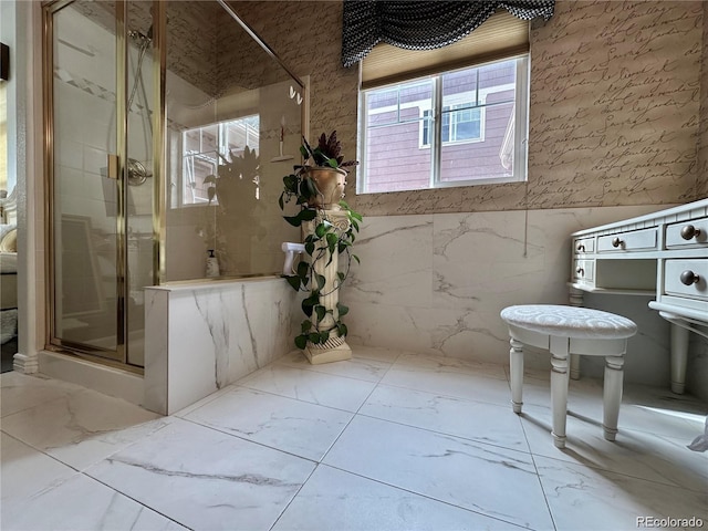 bathroom with a stall shower and marble finish floor