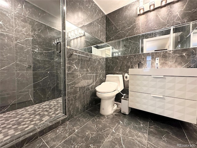bathroom featuring tile walls, toilet, vanity, marble finish floor, and a stall shower