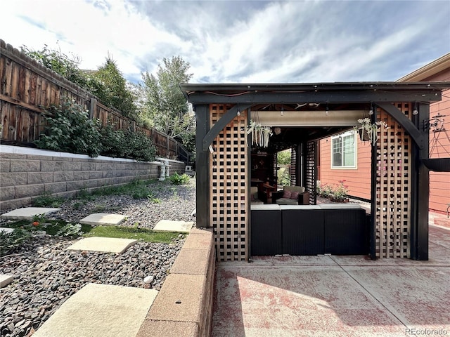 exterior space featuring an outdoor hangout area and fence